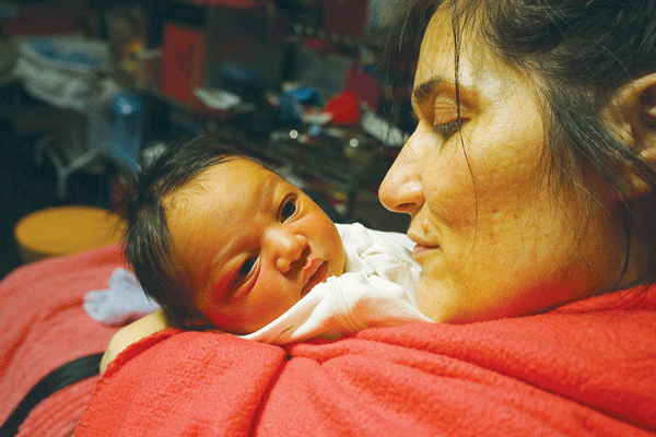 Theresa Byrnes holding her son, Sparrow Joe Louis, a few days after his birth on Feb. 13. Photo by Sarah Ferguson