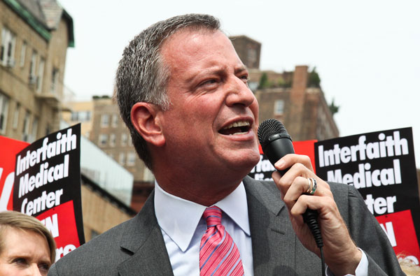 Bill de Blasio — speaking at a “Hospitals Not Condos” rally in the Village last summer — promised to listen to the community and stakeholders, but must do it, the writer says. PHOTO BY TEQUILA MINSKY