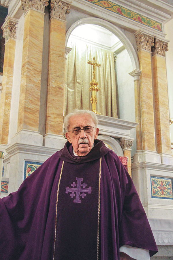 Father Fabian Grifone on Ash Wednesday in front of the altar at the Church of Most Precious Blood.   Photos by Tequila Minsky