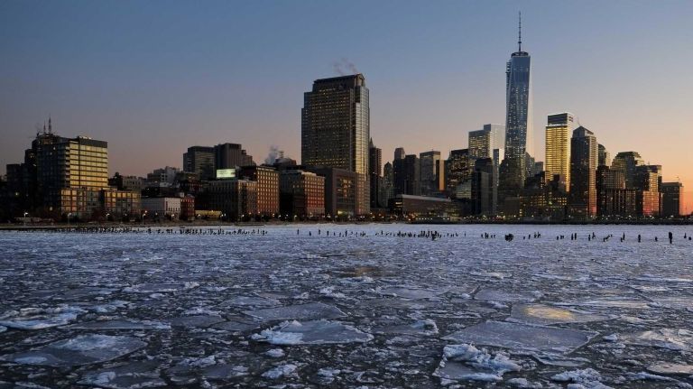 Ice floes fill the Hudson River as the Lower Manhattan skyline is seen during sunset in New York City on Jan. 9, 2013.