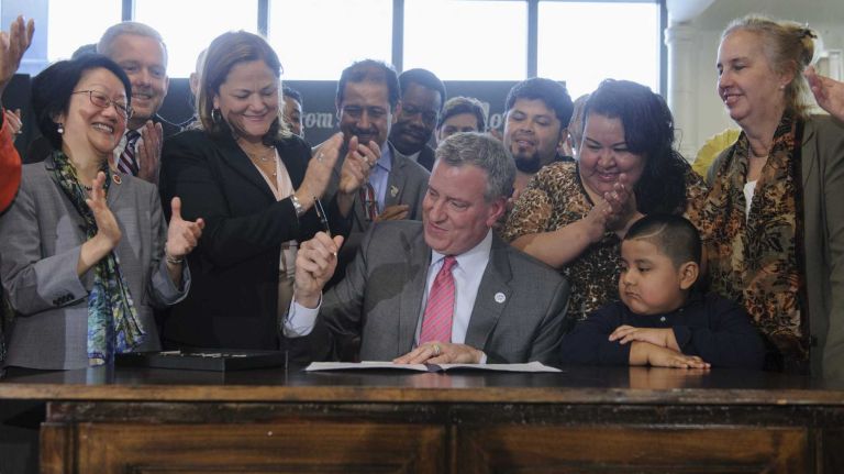 New York City Mayor Bill de Blasio is joined by New York City Council members, City Council Speaker Melissa Mark-Viverito, Manhattan Borough President Gale Brewer and others as he signs the paid sick leave bill into law in on March 20, 2014. 