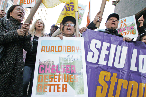 Photo by Sam Spokony Signs of solidarity: Members of 32BJ SEIU join underpaid non-union workers at an April 10 march.