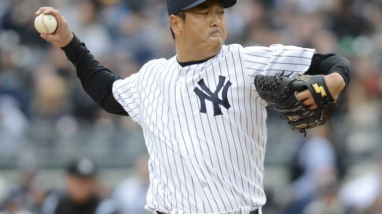 Hiroki Kuroda throws in the first inning of the Yankees' home opener against the Baltimore Orioles at Yankee Stadium on April 7, 2014.