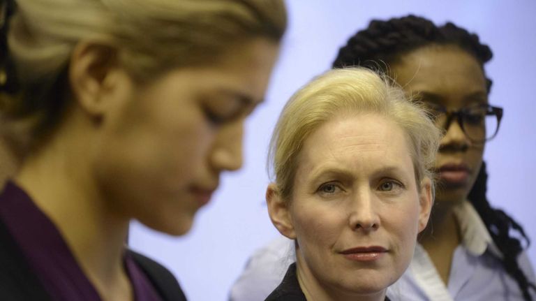 U.S. Senator Kirsten Gillibrand , center, listens as Emma Sulkowicz, left, a sexual assault survivor who attends Columbia University, reads a statement during a news conference attended by sexual assault survivor Wagatwe Wanjuki, right, who attented Tufts University, New York City students and college campus sexual assault survivors in the Senators Manhattan office on Monday, April 07, 2014. Sen. Gillibrand is launching a new effort to combat sexual assaults on college campuses, which studies show effect nearly one in five women in college nationwide.