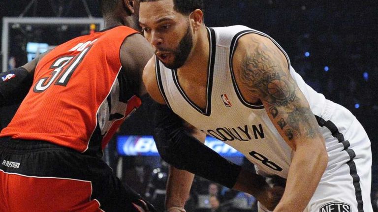 Deron Williams loses the ball against Raptors forward Terrence Ross in the first half during Game 4 of their first-round playoff series at Barclays Center on Sunday, April 27, 2014.