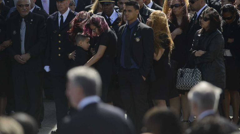 NYPD Officer Dennis Guerra remembered at memorial, funeral 29 Family members react as the coffin of fallen NYPD Officer Dennis Guerra is carried into St. Rose of Lima Roman Catholic Church for his funeral Mass on Monday, April 14, 2014. Guerra, 38, died early Wednesday of smoke inhalation and carbon monoxide poisoning after he and fellow officer Rosa Rodriguez were overcome by dense smoke and toxic fumes in a Coney Island high-rise fire on April 6.