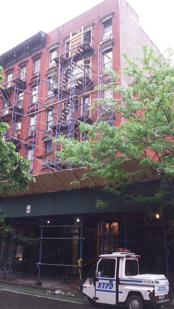 After bricks fell off the front facade of 85 Christopher St. last week, the building was vacated. But some tenants are now back.  Photo by Lincoln Anderson 