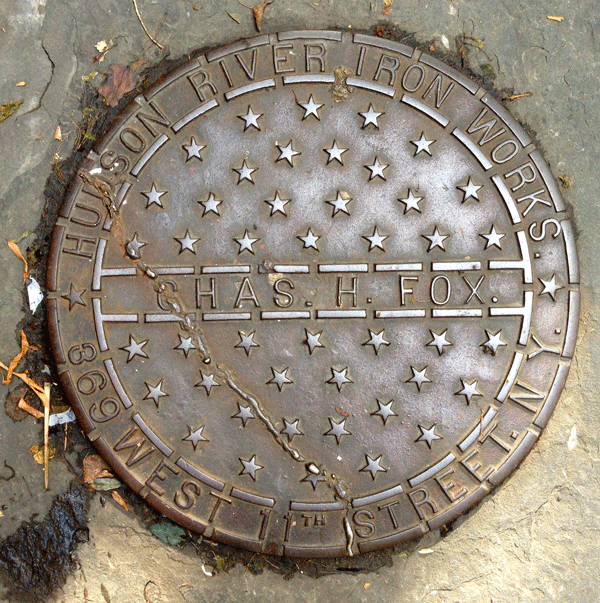 This coal chute cover on W. 11th St. is similar to the one — also made by Hudson River Iron Works and sporting stars — that the writer says was filched from in front of her Bethune St. home two months ago.