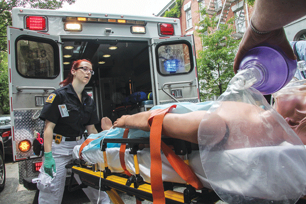 New York-Presbyterian Hospital medics on W. 13th St. loaded a “patient” needing further care into an ambulance bound for “Presby.”  PhotoS by Tequila Minsky