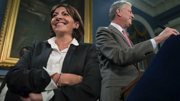 New York Mayor Bill de Blasio introduces Anne Hidalgo, the newly elected first female mayor of Paris, during a press conference at City Hall on Friday, May 30, 2014.