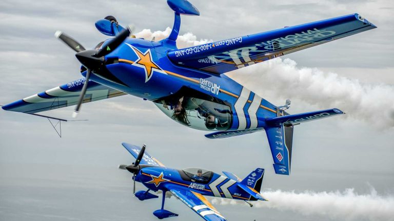 Jones Beach Air Show 2014 33 Aerobatic pilot John Klatt, foreground, takes Newsday reporter Tara Conry for a tour of Long Island, alongside fellow aerobatic pilot, Jeff Boerboon, background, on May 21, 2014, as they prepare for their event at the Bethpage Air Show.