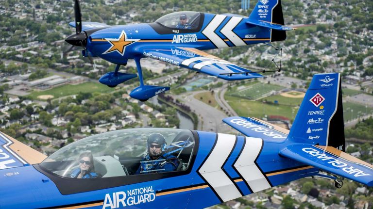 Jones Beach Air Show 2014 34 Aerobatic pilot John Klatt, foreground, takes Newsday reporter Tara Conry on a tour of Long Island, alongside fellow aerobatic pilot Jeff Boerboon, background, on May 21, 2014, as they prepare for their event at the Bethpage Air Show.
