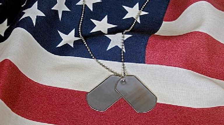 This file photo shows dogtags and an American flag.