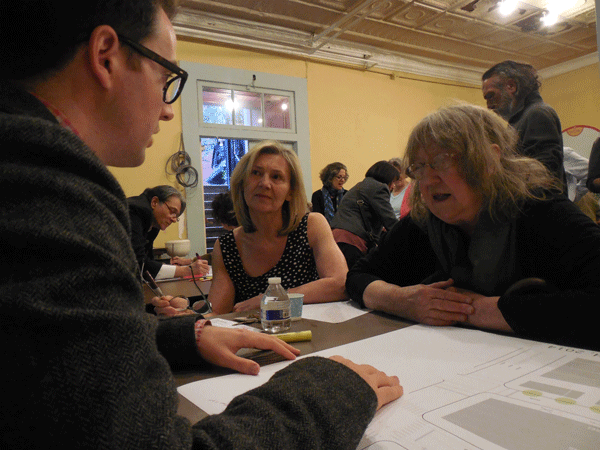 Georgette Fleischer, center, and Minerva Durham, right, speaking with D.O.T.’s David Breen about the plaza plan at the May 5 meeting.  PHOTO BY GERARD FLYNN