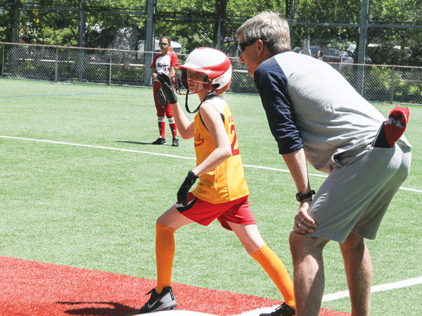 A D.L.L. player looked ready to motor as her first base coach stood by waiting to tell her to “Go!”