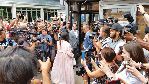 Kourtney (in pink) and Khloe Kardashian (in front of her) toured 63 Spring St. last Thursday. Jack Terzi (in sunglasses) and Ricky Braha (open shirt collar) of JTRE Holdings personally showed them around the space.  Photo courtesy JTRE Holdings