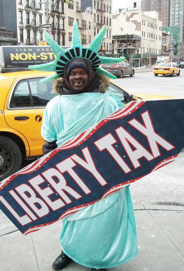 Donald Dushain wasn’t feeling too taxed by the bitter cold. Moving around and drinking coffee helped him stay warm.   Photo by Heather Dubin