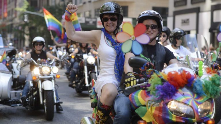 Members of the Sirens women's motorcycle club ride toward the start New York City's gay-pride parade on June 29, 2014, in Manhattan. The parade this year marks 45 years since the raid on the Stonewall Inn, and the riots that followed, starting America's gay-rights movement.