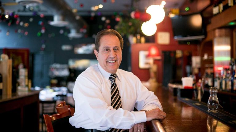 Owner Phil Mouquinho poses for a photo inside PJ Charlton's Restaurant in Hudson Square, Manhattan on May 28, 2014.