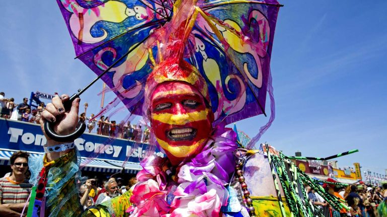 A colorful participant marches along the boardwalk during the annual Coney Island Mermaid Parade on Saturday, June 21, 2014.