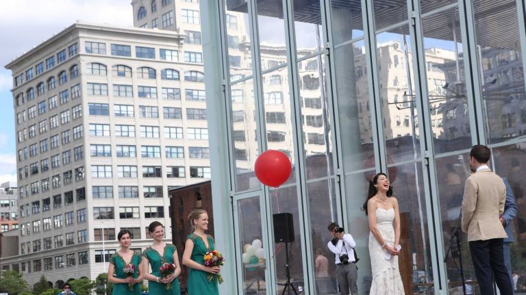 A wedding takes place in front of Jane's Carousel in Brooklyn Bridge Park in Dumbo on June 6, 2014.