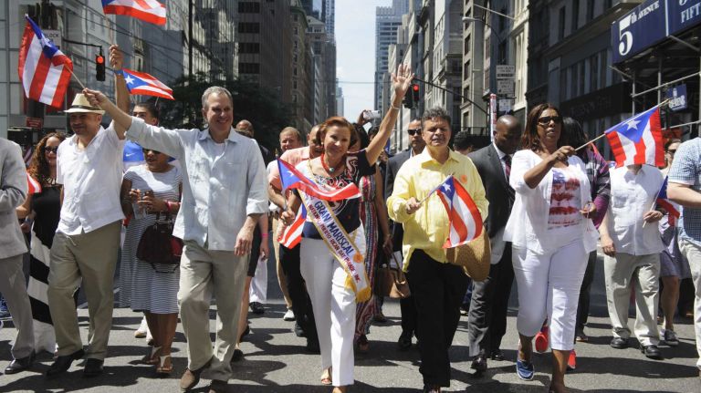 New York Attorney General Eric Schneiderman, second from left, Rep. Nydia Velázquez, center, and Public Advocate Letitia James, second from right, march in the the 57th annual National Puerto Rican Day Parade in Manhattan on Sunday, June 8, 2014.