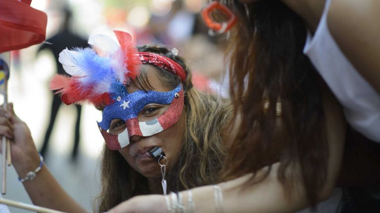 Revelers cheer and wave their flags along Fifth Avenue during the 57th annual National Puerto Rican Day Parade in Manhattan on Sunday, June 8, 2014.