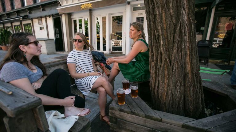 Kelsey Delmote, Tenley Allen, and Colleen Hanson grab a drink at the Earn Inn in Hudson Square in Manhattan on June, 1, 2014. 
