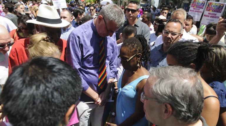 New York Mayor Bill de Blasio, and his wife Chirlane McCray, observe a moment of silence during pride parade in Manhattan on Sunday, June 29, 2014.