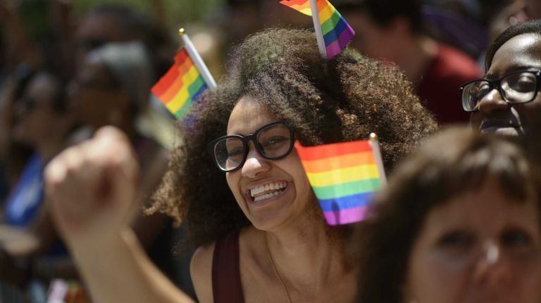 Alyx Darensbourg, center, of Brooklyn, celebrates during New York City pride parade in Manhattan on Sunday, June 29, 2014.