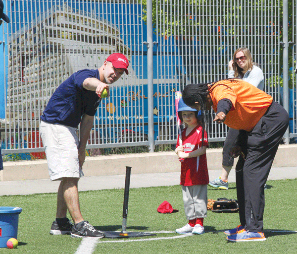 Getting the signal. Pointing the way to first base for a young Coyote T-baller.