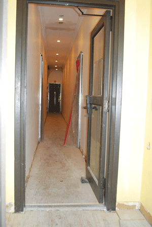 Photo by Winnie McCroy The entryways of 222-224 W. 21st St. are hung with plastic barriers that workers pass through to carry garbage cans full of drywall and other dismantled building parts.  