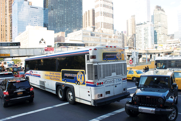 Hell’s Kitchen Bus Congestion Bedevils 2 Photo by Zach WIlliams A jeep turns against traffic while a Coach USA bus blocks the intersection of 10th Ave. and W. 39th St.