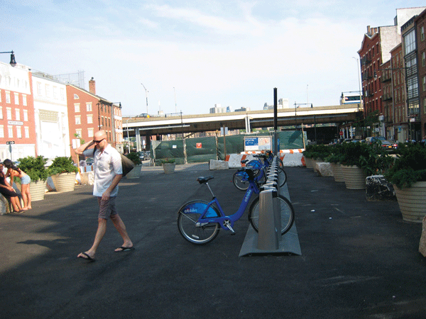 Downtown Express photo by Dusica Sue Malesevic This CitiBike station at Peck Slip has taken over a temporary children’s play space, but Community Board 1 says there’s room on the block for both.
