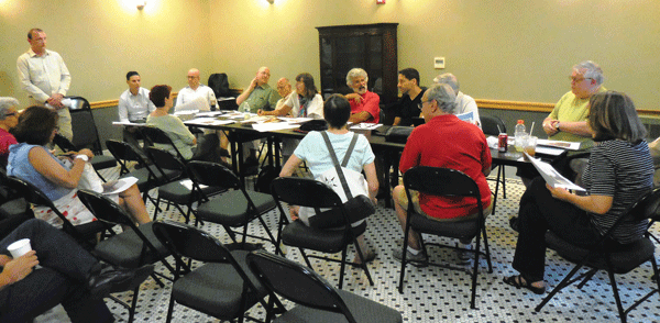 Mike Rosani (standing) presents plans for a Royal Paper Corporation sign to the Chelsea Land Use Committee.Photo by Eileen Stukane