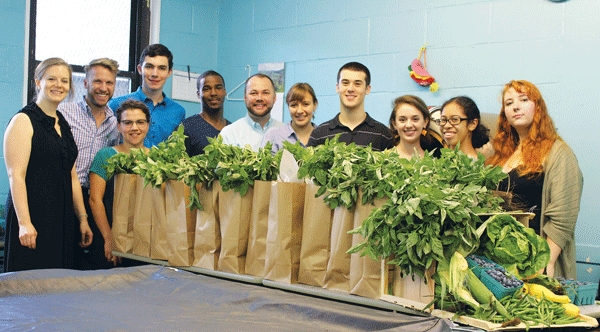 In the Bag: Good Produce at a Great Price 1 Photo by Jeffrey C. LeFrancois Staff and interns join City Councilmember Corey Johnson (center) to prepare food bags for distribution.
