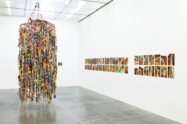 Installation view of the Lobby Gallery, including (at left) Hassan Sharif’s “Suspended Objects” (2011, mixed mediums, 137 3/4 [h] x 63 [d] in; 350 [h] x 160 [d] cm approx.). At the New Museum, through Sept. 28.  Photo by Benoit Pailley, courtesy New Museum, NY 