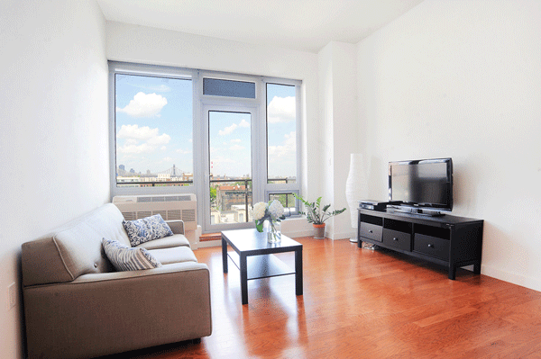 The living room of a one-bedroom condo at 5-49 Borden Ave.  Town Residential  
