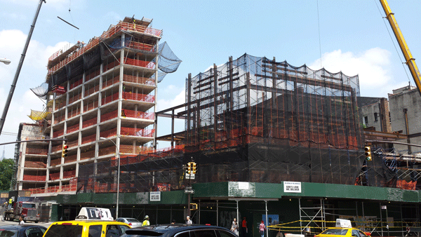 Super-luxe building soaring next to God’s Love 1 Works in progress: One Vandam, left, and G.L.W.D. Photo by The Villager