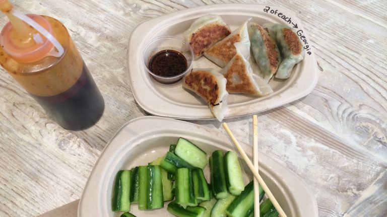 Mimi's secret sauce, pickled cucumbers and a plate of dumplings. 