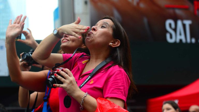 Fans show their love for New York City's Bravest firefighters and calendar models in Times Square on July 15, 2014.
