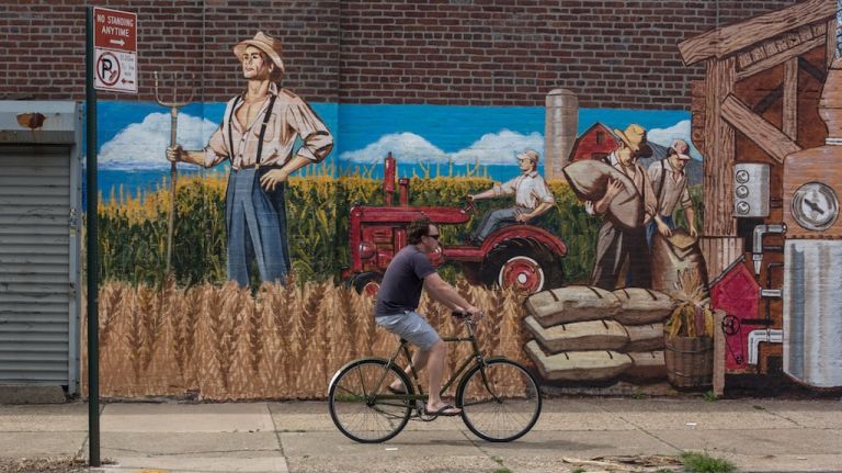 A man rides a bike down Conover Street in Red Hook. 