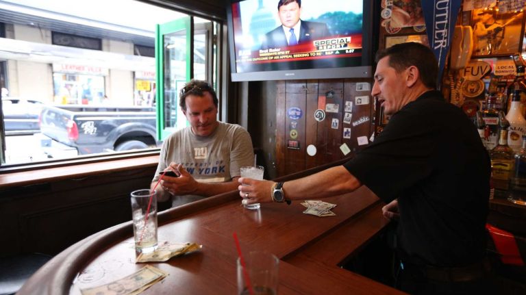 Bartender, Michael Higgs, serves patrons at the  Blarney Rock Pub at 137 W. 33rd street ,Wednesday, July 16, 2014. Many business near Penn Station would be affected by an LIRR strike.