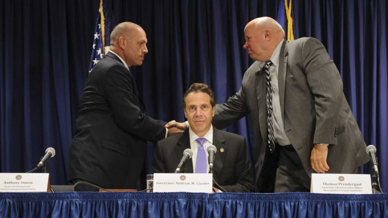 Lead Long Island Rail Road union negotiator Anthony Simon, left, shakes hands with MTA chairman Thomas Prendergast, right, after Gov. Andrew M. Cuomo announces a tentative deal averting a LIRR strike, on Thursday, July 17, 2014.