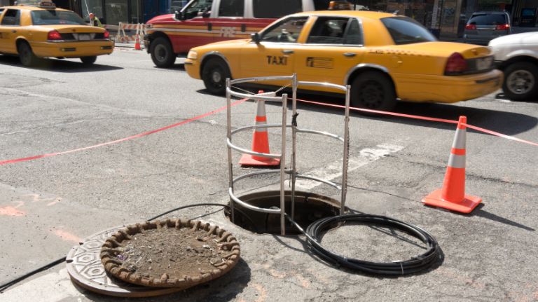 Open manhole cover in New York City.
