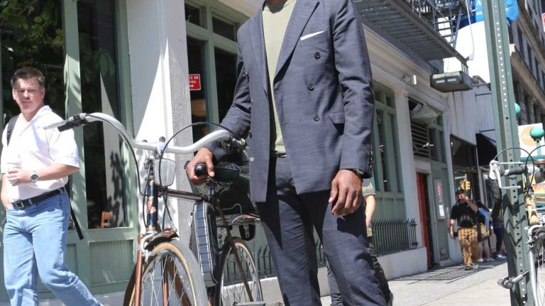 Marc Henry, 35, an actor from Crown Heights, wears a double-breasted wool Calvin Klein suit while riding his bicycle in SoHo. 