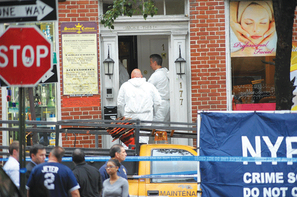 Crime-scene detectives recovering bullet shells and investigating the premises at the Smoking Culture NYC store, on W. Fourth St., on Monday after the shootout between fugitive Charles Mozdir and three officers.  Photo by Jason B. Nicholas
