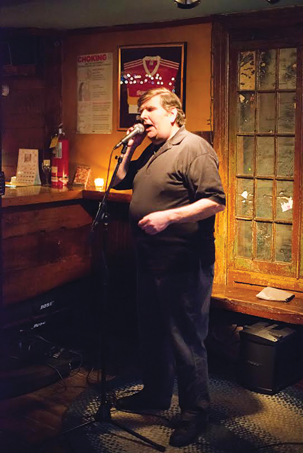 Show me the meaning of the word: Dennis Driscoll, in performance at The Scratcher Sessions.  Photo by Paul Quinn