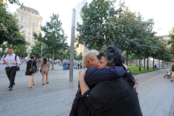 Downtown Express file photo by Terese Loeb Kreuzer Two Downtown residents, Susan Cole, left, and Diane Lapson, embraced at the 9/11 Memorial at last September’s community night event.