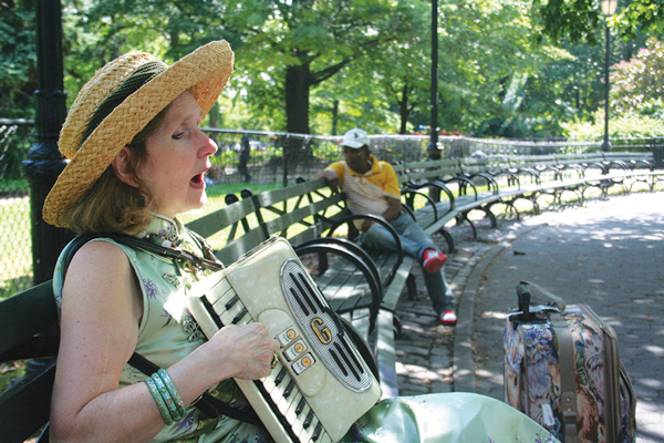 Helen Stratford playing one of her accordions in Tompkins Square Park.  Photo by Yannic Rack